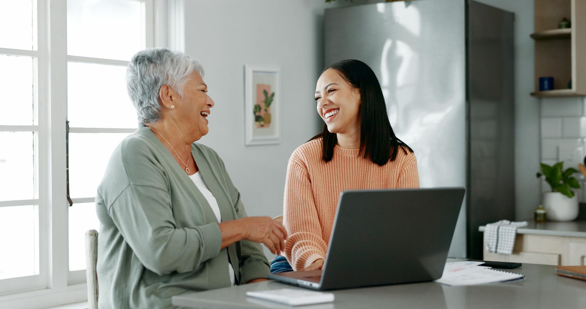 A Medicare agent helping a senior woman, they are both happy and smiling